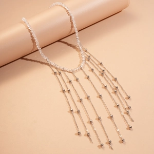 Macro shot of glass crystal bead chain with layered silver metal fringe tassels detail