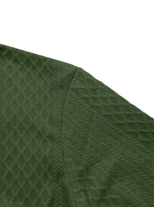 Detail of dark green knit shirt featuring textured diamond pattern and ribbed stripe cuff
