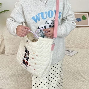Detail of white quilted heart tote bag with cute black cat print and soft pink shoulder strap