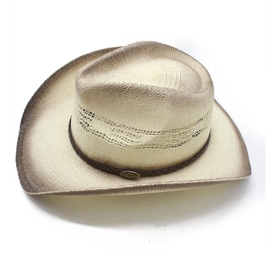 Detail of western straw cowboy hat featuring breathable hollow weave and gradient brim