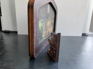 Side view detail of wooden Nativity plaque with architecture design and display stand