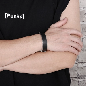 Detail of mens punk black leather bracelet with braided metal chains on wrist