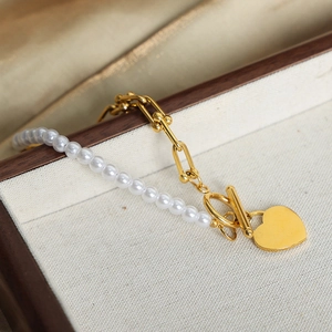 French style gold U-link chain bracelet with white pearls and a heart pendant
