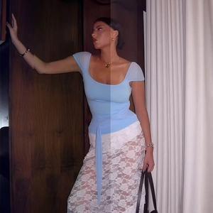 Detail view of light blue square neck top with sheer sleeves and tie waist ribbon design