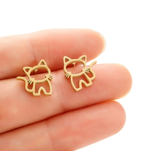 Minimalist gold hollow cat stud earrings in stainless steel shown being held for scale