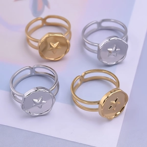 Detail view of 304 stainless steel double band rings with embossed stars in gold and silver
