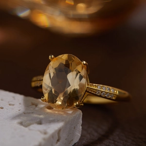 Macro detail of a 925 silver ring with oval yellow citrine and side diamond accents