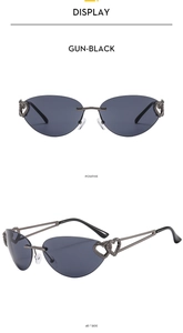 Detail of rimless Y2K cat-eye sunglasses with gun-black double heart hollow metal temples