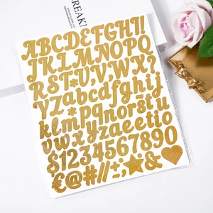 Detail of glitter gold alphabet stickers with letters and numbers on white aesthetic background