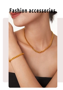 Detail of chic twisted braided gold chain necklace and matching bracelet set on a model