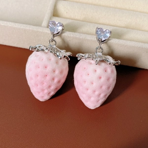 Close-up of pink flocked strawberry earrings with silver metal leaves and heart zircon studs