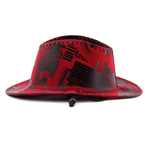 Detail of red cowboy hat featuring black newspaper print and adjustable windproof rope