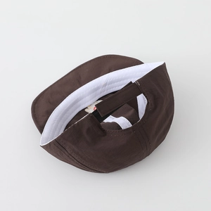 Detail view of coffee baby cap with adjustable velcro strap and cotton sweatband