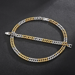 Detail shot of two-tone gold and silver Cuban chain necklace with secure clasp closure