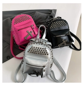 Three mini punk style PU leather backpacks in rose, black, and silver with metal studs