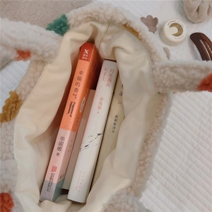 Close-up of plush polka dot tote bag interior showing spacious capacity with books