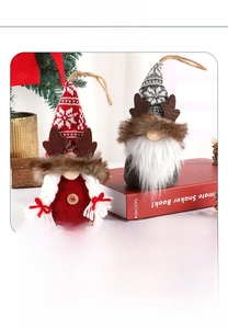 Detail view of red and grey Christmas gnome hanging ornaments with knitted snowflake hats