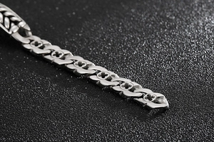 Macro view of polished wheat chain bracelet with hollow clover cross engraving patterns