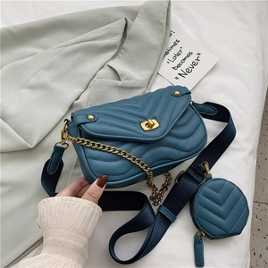 Quilted navy blue chain shoulder bag with wide strap and matching round coin purse