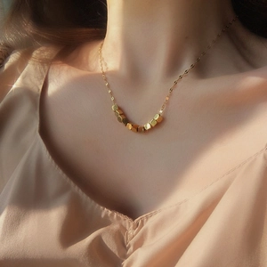 Minimalist gold titanium steel necklace with square geometric pendants worn by a model