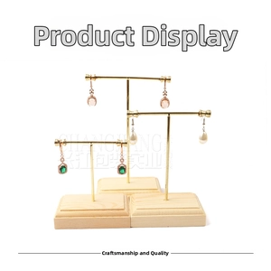Three gold T-bar jewelry stands with wood bases for earrings and ring display
