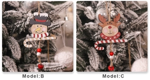 Detail of wooden snowman and reindeer ornaments with red bells on Christmas tree