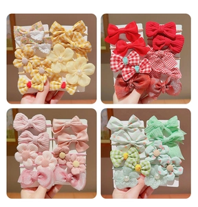 Detail view of colorful bow and flower hair accessories set for kids with diverse patterns