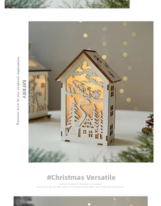 Detailed view of a wooden Christmas LED lantern house with laser-cut Santa Claus scene