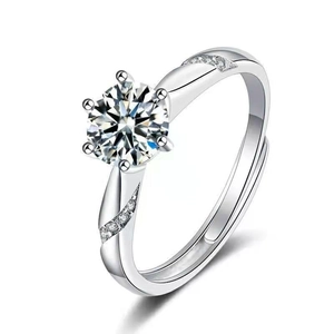 Detailed close-up of a silver ring with six-prong set cubic zirconia and accent diamonds
