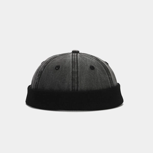 Detail of charcoal washed denim docker hat with black ribbed knit brim and metal eyelets
