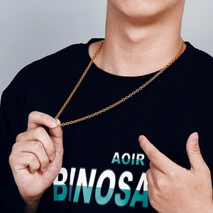 Close-up of a gold-toned stainless steel O-link chain necklace worn by a male model