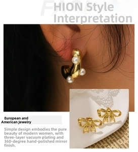 Macro detail of gold bow earrings and pearl ear cuff with mirror finish plating