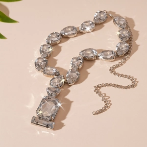 Detailed shot of luxury necklace featuring teardrop and square crystals with sparkling accents