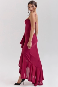 Detail view of burgundy wine red sling dress featuring fish-tail hem with ruffles