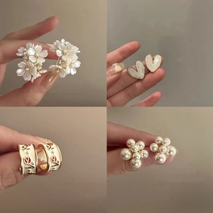 Elegant floral and pearl earrings set in various styles with heart and enamel details
