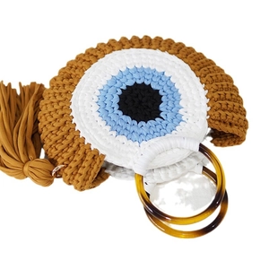 Crochet woven beach tote bag with blue evil eye pattern and brown circular handles