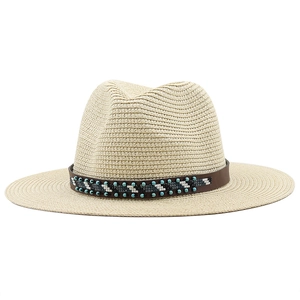 Detail of bohemian hand-woven beads and leather band on a straw sun hat for women