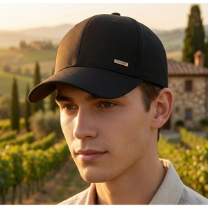 Close-up of black baseball cap with golden FASHION metal plate on a lifestyle background