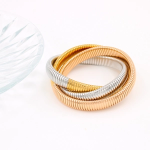 Detail view of tri-color 18K gold-plated stainless steel flexible stretch bracelets