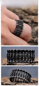 Close-up of vintage punk bone texture ring with distressed silver finish on wood