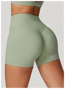 Close-up of high-waisted sage green yoga shorts with scrunch butt lift stitch detail