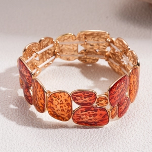 Detail of amber resin texture and gold metal frame on vintage geometric stretch bracelet