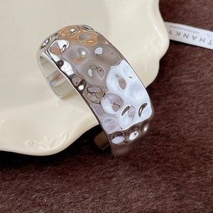 Minimalist silver wide open bangle with liquid metal liquid wave hammered design
