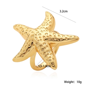 Detailed macro view of 18K gold-plated starfish napkin ring with texture and size metrics
