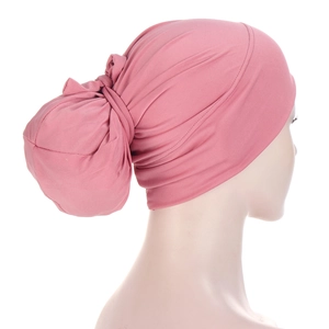 Detail of pink Muslim headscarf with back bun knot on a mannequin head