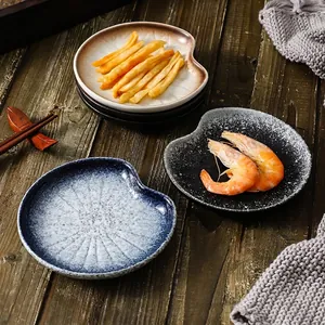 Artistic Japanese style ceramic snack plates set with irregular heart shapes on wood table