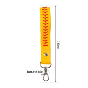 Close-up of yellow leather baseball wristlet with red stitching and a swivel lobster clasp