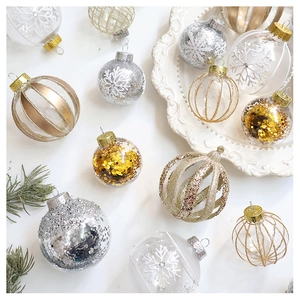 Macro detail of transparent Christmas balls with sequins and snowflake painting on ceramic plate