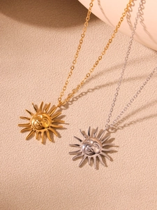 Detail of sun goddess pendant necklaces in gold and silver finish with fine metal chains