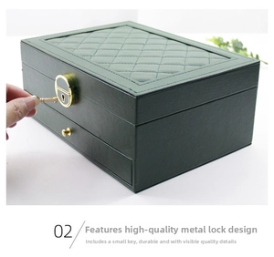 Detail of hand using a key to unlock the dark green leather jewelry box with gold lock